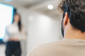 Male person listening to a presentation. Back view. Close up photo