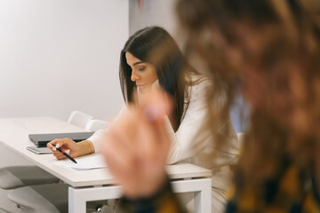 Female student having exam at the classroom