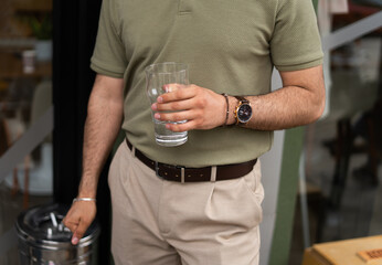 Fototapeta na wymiar Businessman holding a glass of water