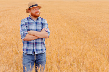 Naklejka na ściany i meble Happy farmer Standing plant in his Wheat field
