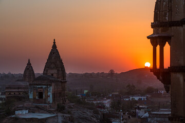 View from a roof top of a temple in idea during sunset with antique tower silhouettes in the...