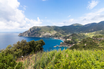 Fototapeta na wymiar Aerial view of Monterosso from trekking trail, one of the five villages along Cinque Terre hiking strech. Popular tourist destination in Italy