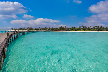 Fototapeta na wymiar Best travel landscape. Exotic island sea bay wooden pier over pristine lagoon leads into beautiful tropical paradise, coco palm trees white sand. Calm water, sunshine. Amazing vacation, luxury resort