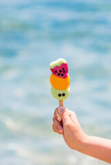 holding colorful fresh fruity ice cream