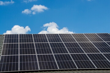 Fototapeta premium House roof with photovoltaic modules.