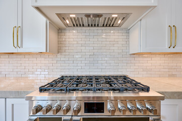 Stainless Gas Stove Top Range and Hood in New Kitchen - 621292374