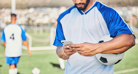 Soccer field, phone and man hands for competition, training or fitness news, social media chat and blog. Football player or person typing on mobile app for sports information, health or goals check