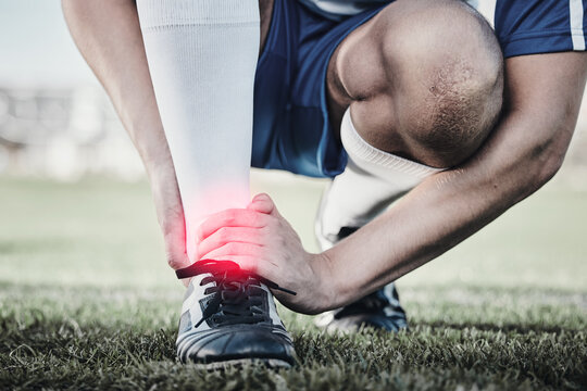 Accident, sports and hand of a man on foot pain, soccer emergency and injury while training. Fitness, problem and an athlete or football player with inflammation or a swollen muscle on the field