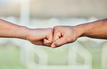 Soccer, fist bump and hands for teamwork, support and sports for training at stadium outdoor. Collaboration, together and football players with motivation for exercise target, workout goal or success