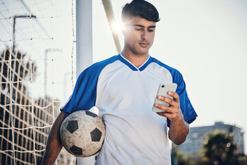 Soccer ball, phone and man on field for competition, training or fitness news, social media chat...