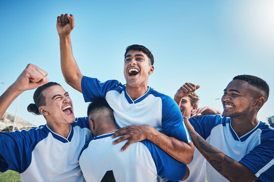 Football player, winner team and people winning in competition, game or sports goals, success and cheers. Yes, wow and excited group of young men with achievement and soccer celebration on blue sky