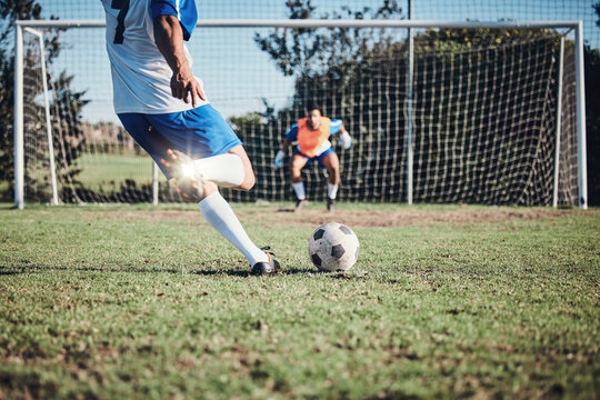 Fitness, penalty and soccer player scoring a goal at training, game or match at a tournament. Sports, exercise and back of male football athlete kick ball at practice on outdoor field at stadium.