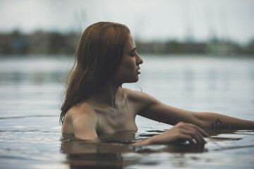 Portrait of naked woman swimming in the lake