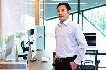 happy mature Asian man looking at camera. Portrait of Confident successful business people woking in home office