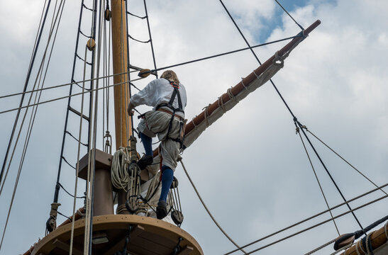 Sailor on lookout deck after climbing the rigging of replica sailing ship that sailed to America