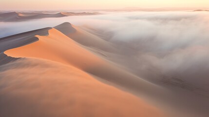 Obraz na płótnie Canvas Drone shot of sand dunes covered in thick fog, sunrise at the Namib desert, in Namibia - view of the desert, Generative AI