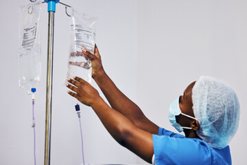Hospital, nurse with face mask and black woman with iv drip medicine, fluid infusion or liquid...