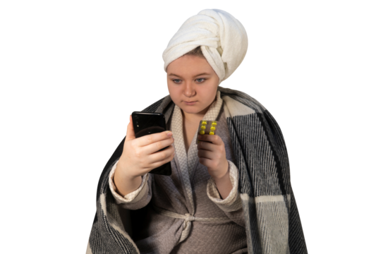 A girl with symptoms of a cold on a transparent background holds a blister of pills in one hand and a smartphone in the other. Online consultation. Health care and home treatment concept