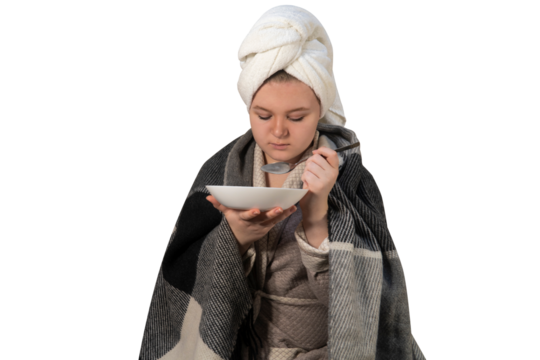 A girl with cold symptoms eats broth from a plate on a transparent background. Concept of medicine, healthcare, pharmacy and home treatment