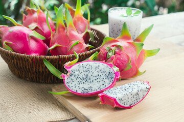 Dragon fruit, Pitaya or Pitahaya, and spun dragon fruit on wooden table in countryside, healthy...