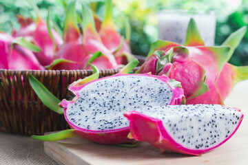 Dragon fruit, Pitaya or Pitahaya, and spun dragon fruit on wooden table in countryside, healthy fruit