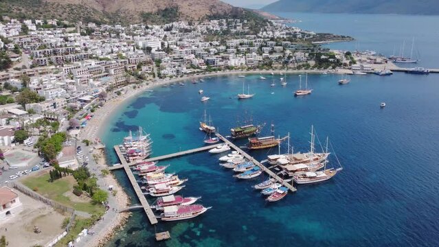 Drone aerial view of scenic seashore bay with turquoise water and boats in Bodrum, Turkey. Traveling at beautiful destination 
