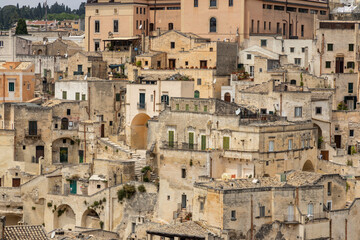 Naklejka premium View of the city of Matera by day. Typical Salento illuminations during the holidays. Feast of the Brown Madonna, Matera. Prehistoric caves from the Murgia.Mysterious and ancient land among the stones