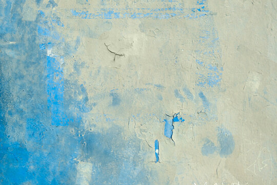 The surface is painted blue and white, faded and cracked from time to time. Background, texture, backdrop.