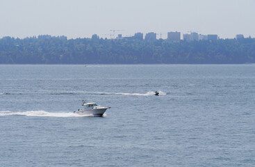Fototapeta premium Boat in the Pacific Ocean in front of the coast of Lighthouse Park, West Vancouver, British Columbia, Canada