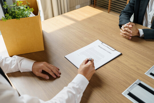 Quit Job Business man sending resignation letter and packing Stuff Resign Depress or carrying business cardboard box in office. Change of job or fired from company.