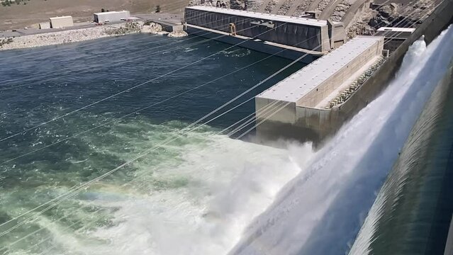 Slow motion view of the water flowing over the spillway of the hydroelectric Grand Coulee Dam taken from on top of the dam, it's very rare to see this. - Eastern Washington, USA