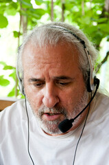 old man working as a freelancer. Self-employed man pursuing a freelance career. hispanic senior man...