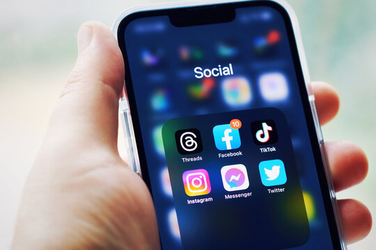 Moscow, Russia, 08-07-2023: Threads app icon on smartphone screen with other social media apps. Man arm hold smartphone to run Threads app. Threads social media network. Shallow DOF