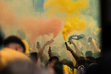 Colored smoke dye being grabbed by people on the streets,  supporters crowd celebrating before a...