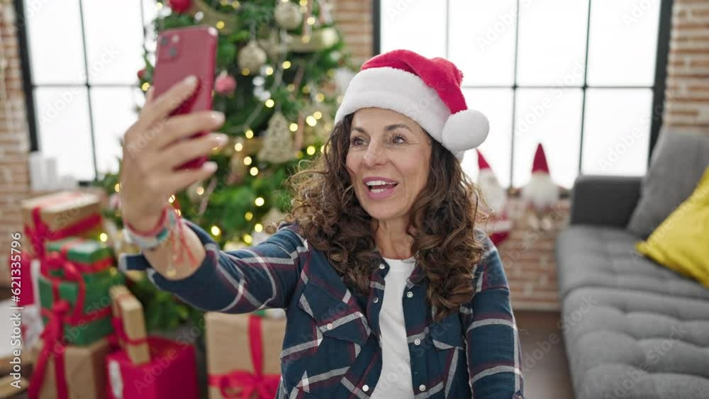 Sticker middle age hispanic woman having video call celebrating christmas at home