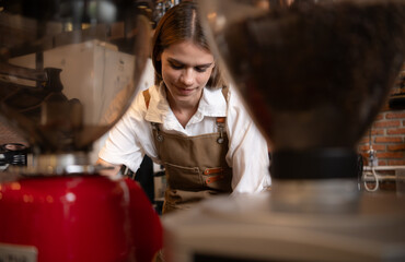 Fototapeta na wymiar Close-up of barista hands using Portafilter for making espresso.