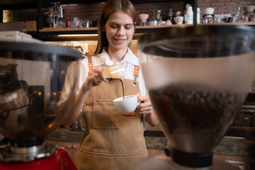 Close-up of barista hands using Portafilter for making espresso.
