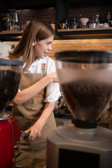 Close-up of barista hands using Portafilter for making espresso.