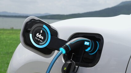 Electric car plug in with charging station, recharge battery by EV charger cable display smart digital battery status hologram with nature background. Futuristic green energy infrastructure.Peruse