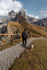 hiker with dog in the mountains dolomiti 