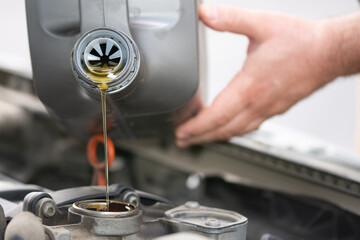 a jet of automotive oil is poured into the car