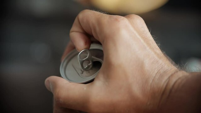 Opening can with soda water .