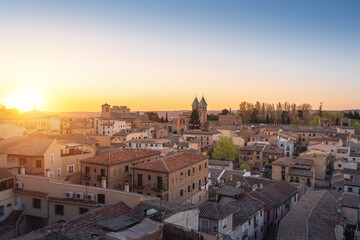 Fototapeta na wymiar Toledo Skyline at sunset with Puerta de Bisagra Nueva Gate and Church of Santiago del Arrabal - Toledo, Spain