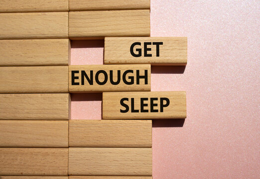 Get enough sleep symbol. Wooden blocks with words Get enough sleep. Beautiful pink background. Healthy lifestyle, medical and Get enough sleep concept. Copy space.