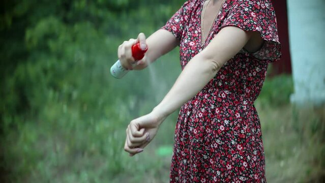 Woman anti mosquito fleas spray . Spraying repellent insects ticks