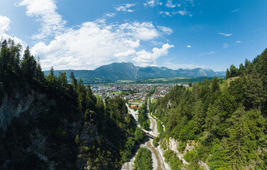Fototapeta na wymiar Aerial View of the small Town Kundl in the Region of Tyrol, Austria, overlooking the Inntal Valley during Summer.