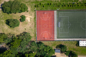Aerial view on a basketball and football court in the park. drone photography. court without people 
