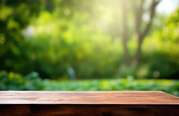 Empty wooden table over blurred green nature park background, product display montage High quality photo