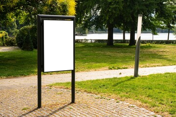 White vertical billboards in a park in Germany.