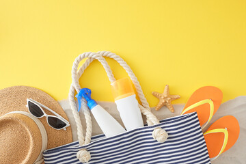 Summer skincare concept for sensitive skin. Top view flat lay of UV-protection cosmetic, handbag, beach accessories, starfish, sand on yellow background with blank space for ads or message